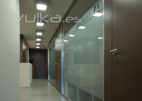 Divisorias acristaladas decoradas con vinilos personalizados, que permiten privacidad y paso de luz.