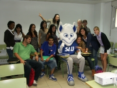 The billiken, mascot of saint louis university, visits the madrid campus and joins the students for a class