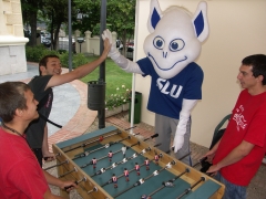 The billiken joins students for a game of futbolin, or foozball, and dominates
