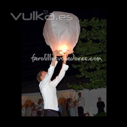 novio lanzando un farolillo de los deseos al cielo