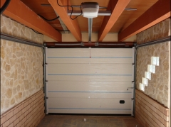 Garaje seccionales : vista interior de puerta seccional con  railes superiores y motor de techo