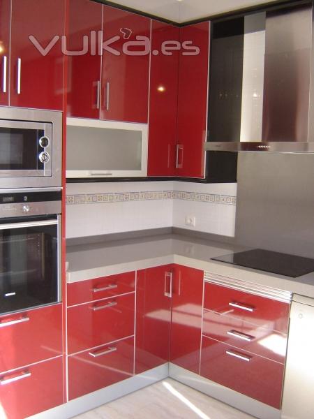 Cocina en formica brillo combinando los colores granate y negro con los cuatro cantos inox. Encimera en Silestone ...