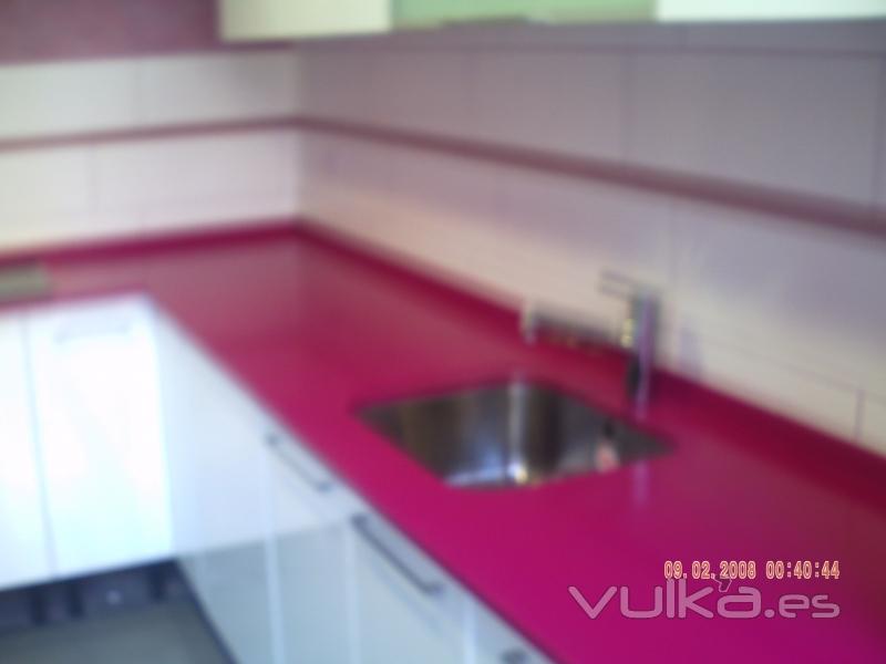 Cocina con un precioso silestone fucsia.