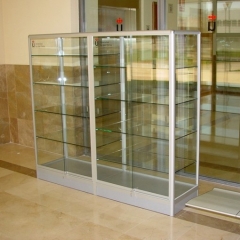Vitrina de perfilería de aluminio de doble cuerpo con puertas correderas y zócalo.